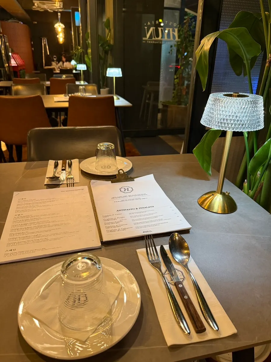 A table setting at Osteria Hyeon marked with a reservation name