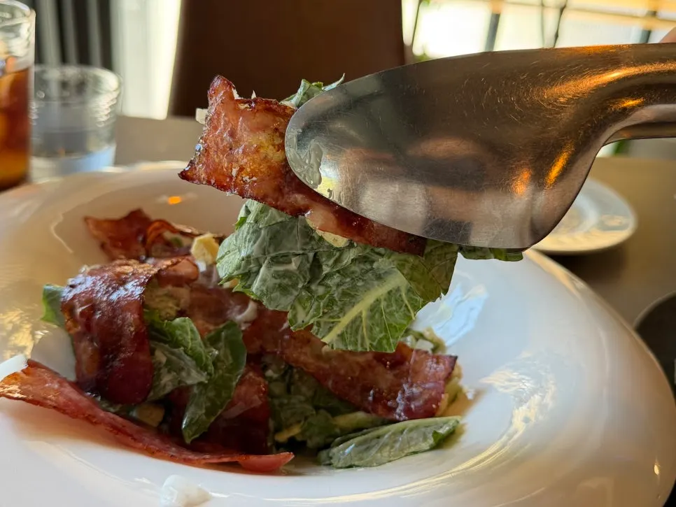 Osteria Hyeon Caesar salad topped with crisp bacon