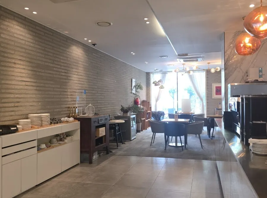 Dining hall interior with bright walls and marble-like finish