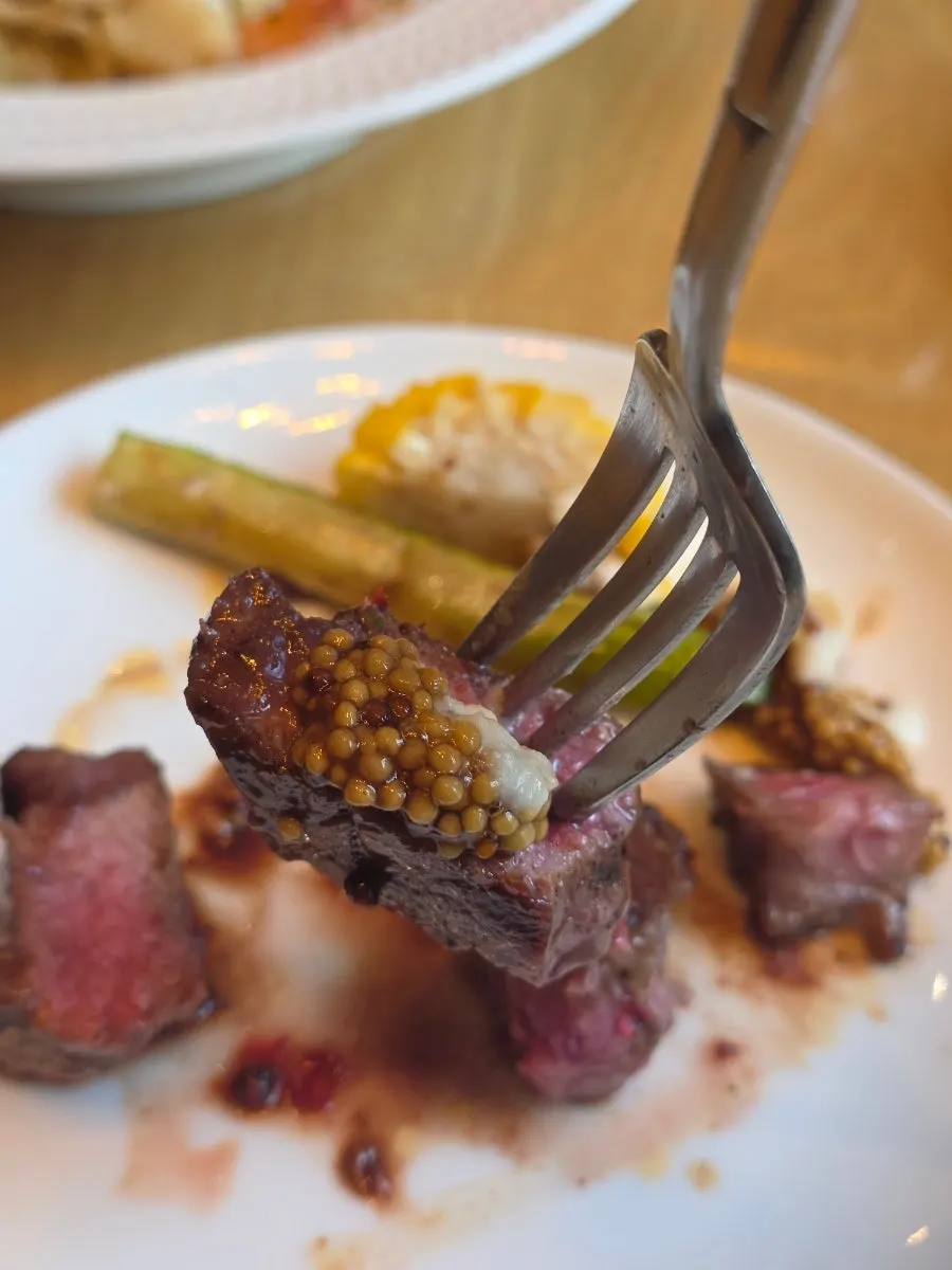 Steak plate topped with pink peppercorns