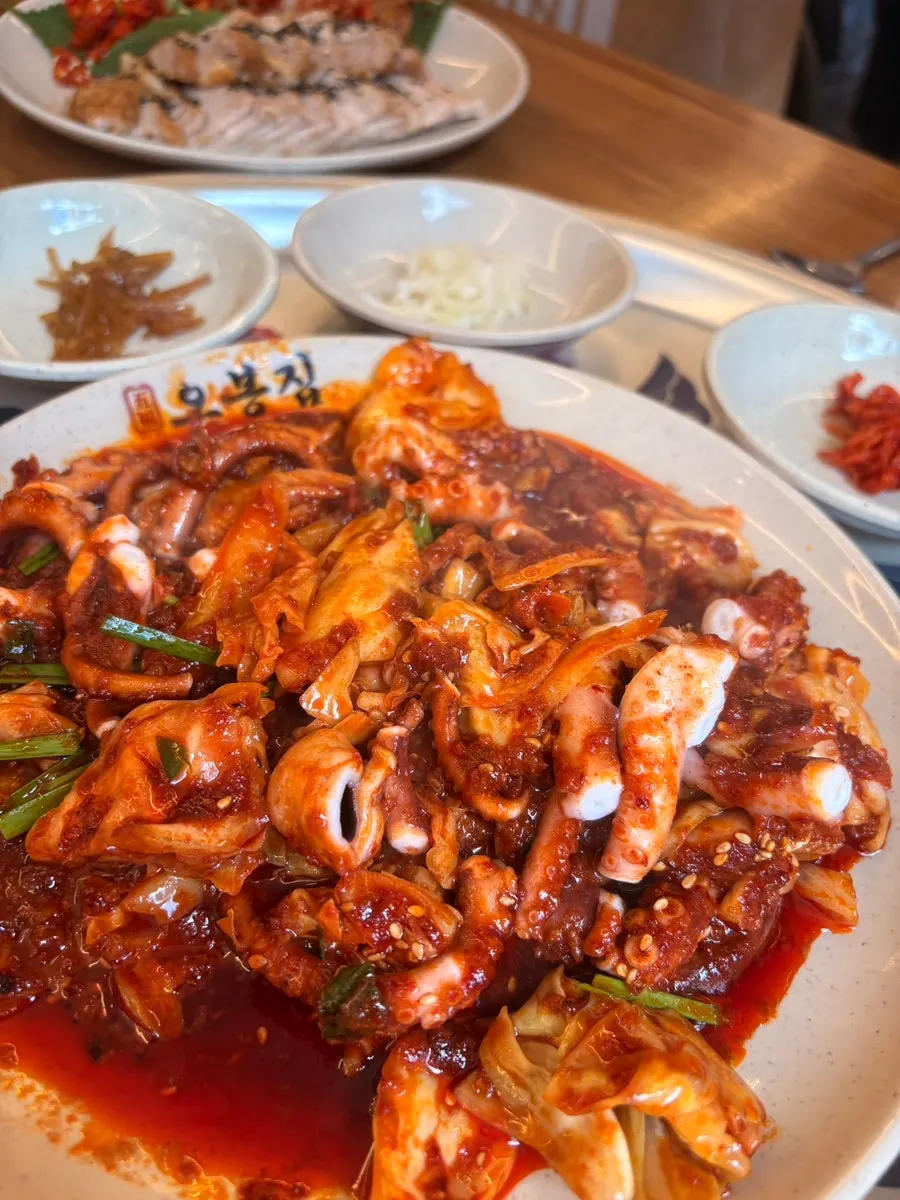 Fire-grilled octopus stir-fry topped with chives and sesame seeds