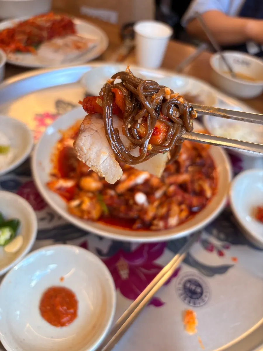 Jaengban makguksu served alongside bossam