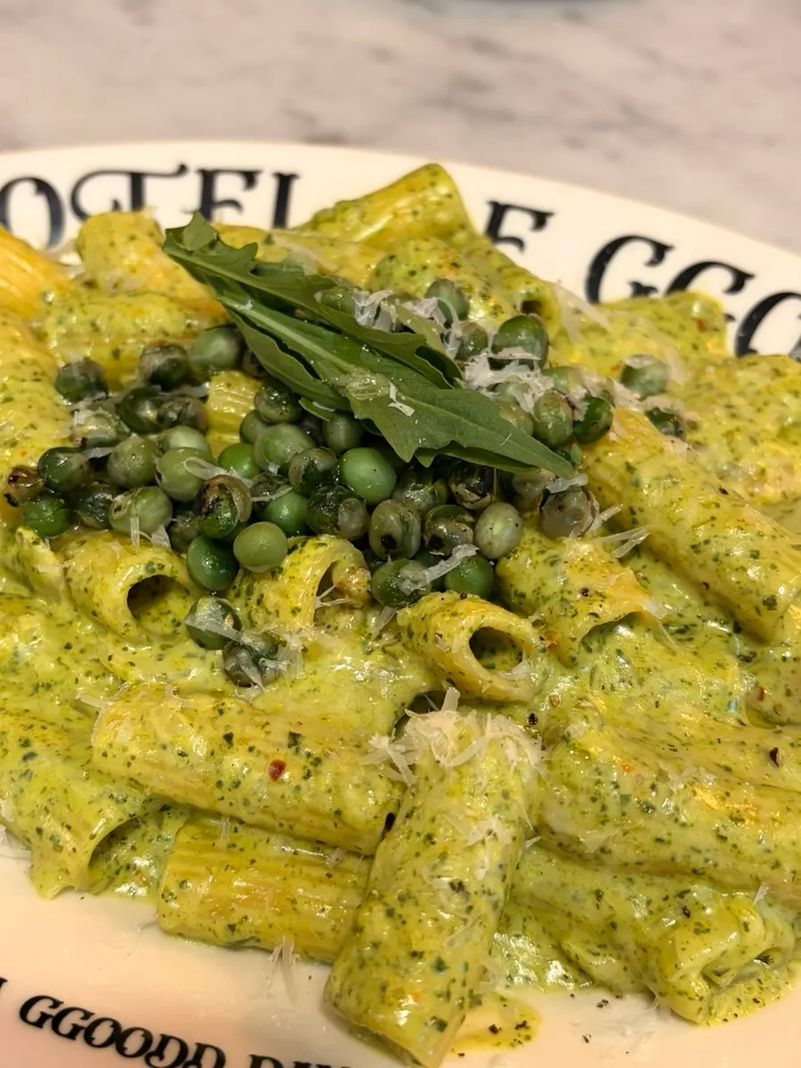 Basil cream pasta topped with toasted peas