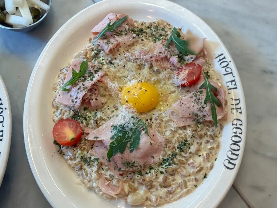 Close-up of rosé pasta topped with whole-cut bacon