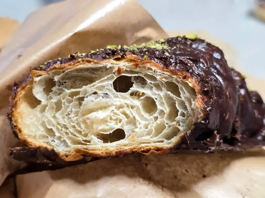 Close-up of the croissant topped with pistachio powder