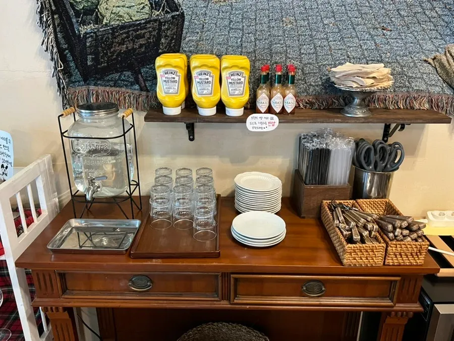 Self-bar with water, cups, and sauces