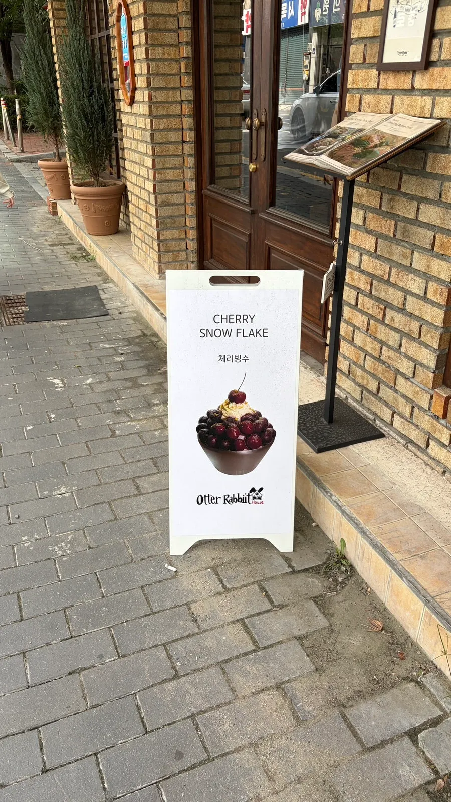 Cherry bingsu sign posted outside the café