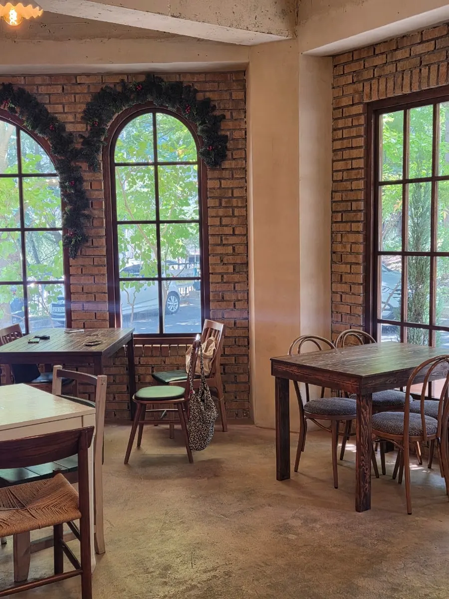 Café interior with ivory walls and wood furniture