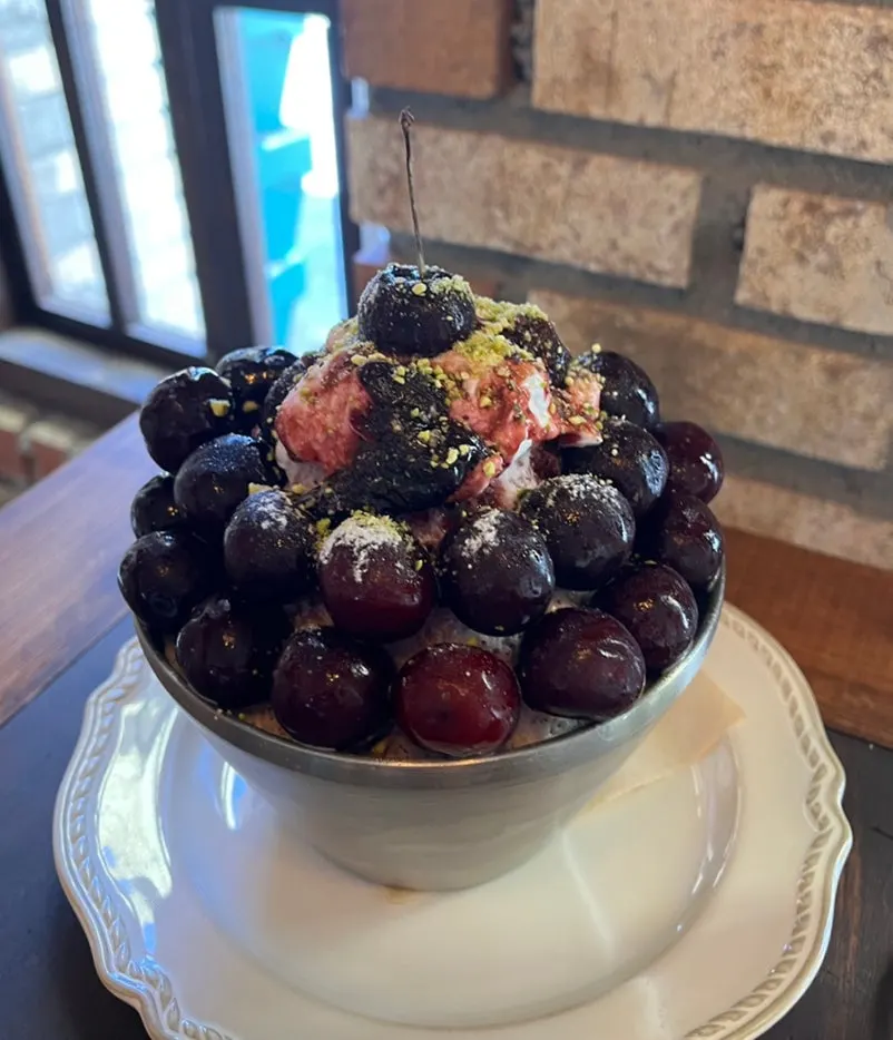 Table spread of cherry bingsu and ade