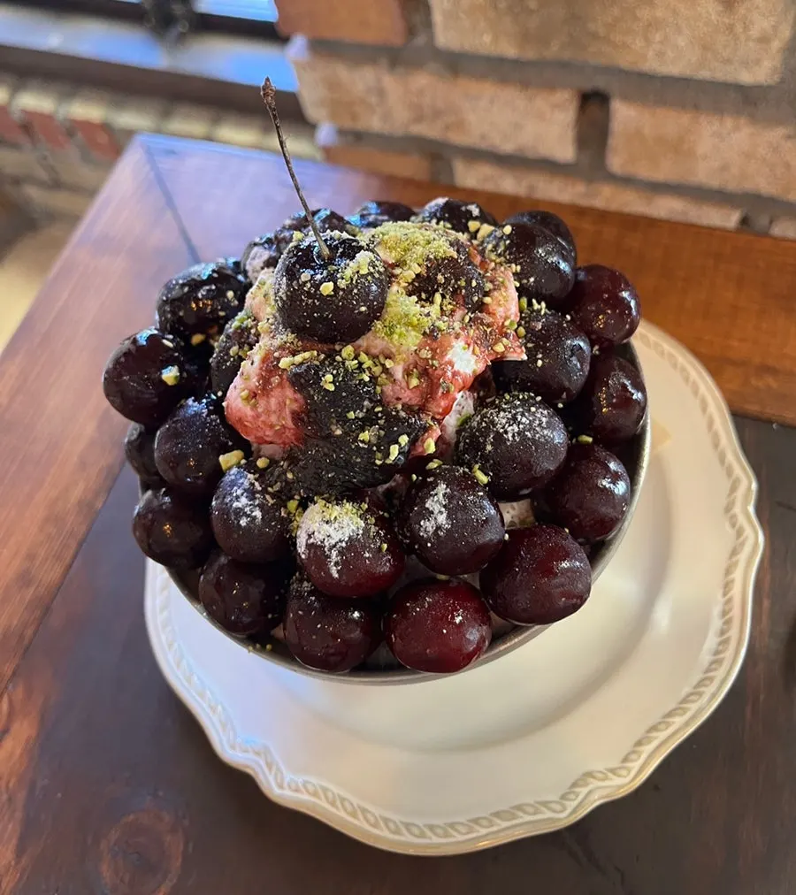 Bingsu topped with mascarpone cream cheese and pistachio powder
