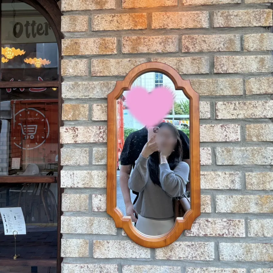 Aesthetic mirror-selfie spot at the café entrance