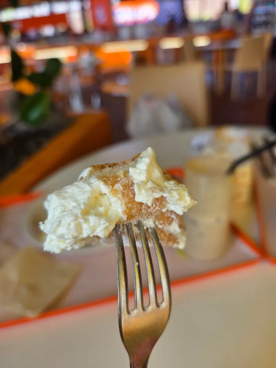 Close-up of a bakery item generously filled with cream