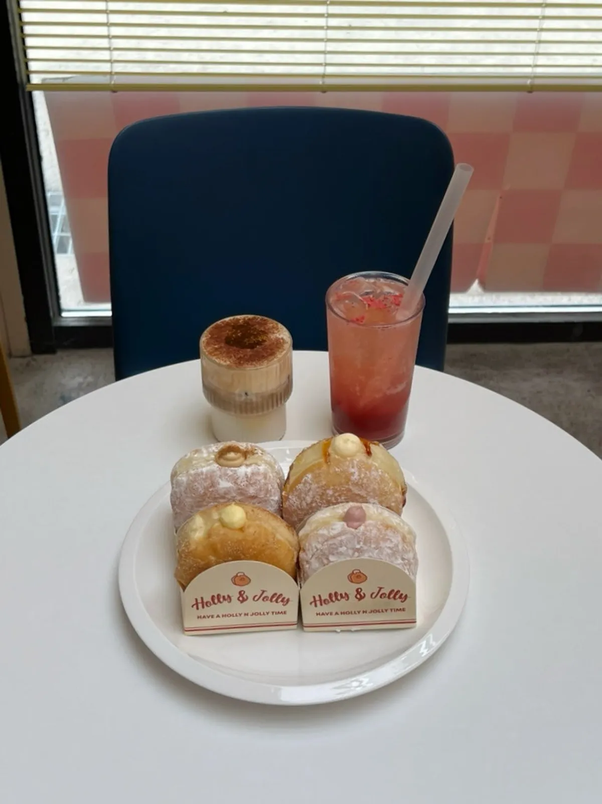 Table spread with four doughnuts and two drinks