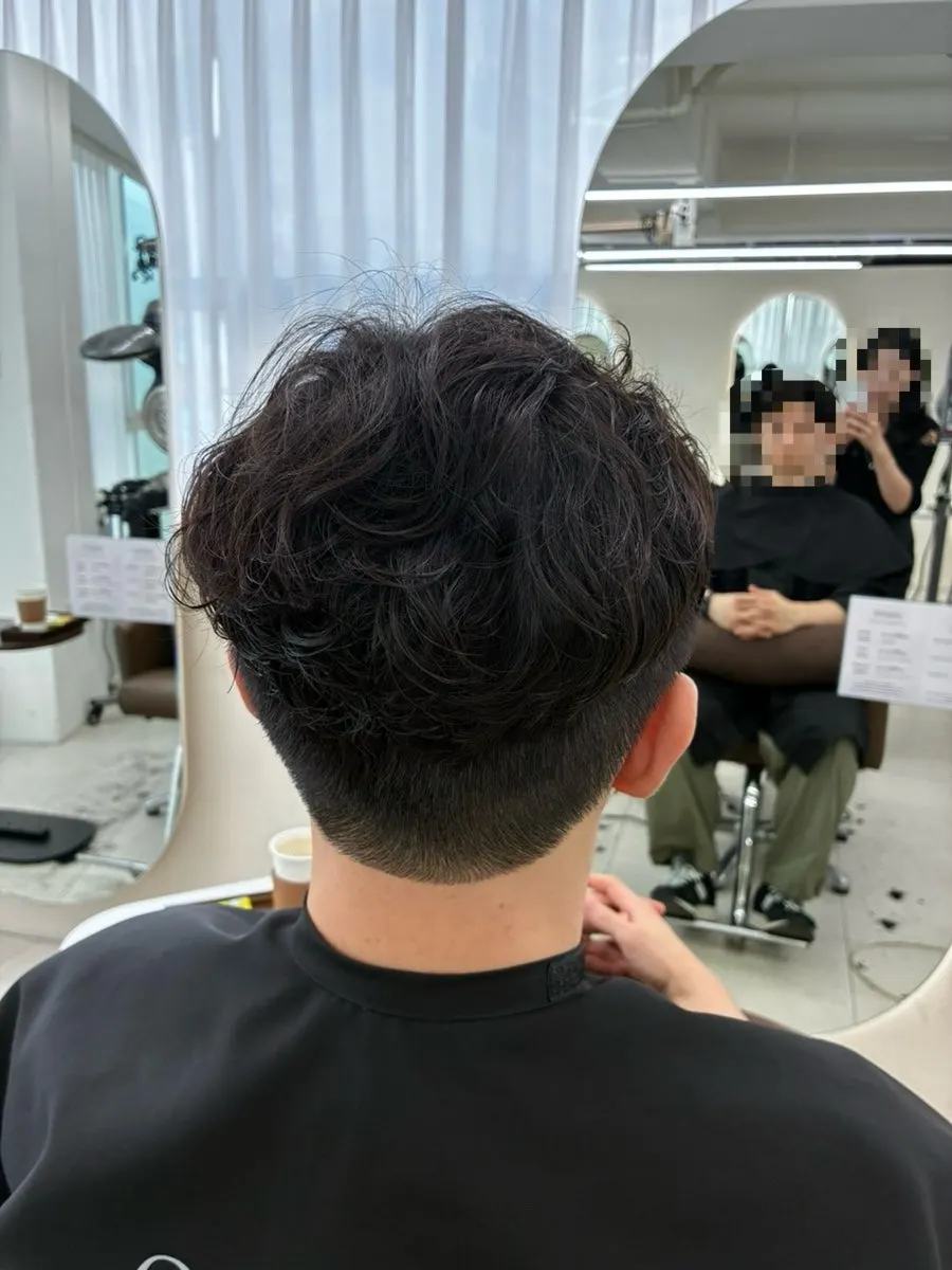 Front view of the finished men's side-part perm