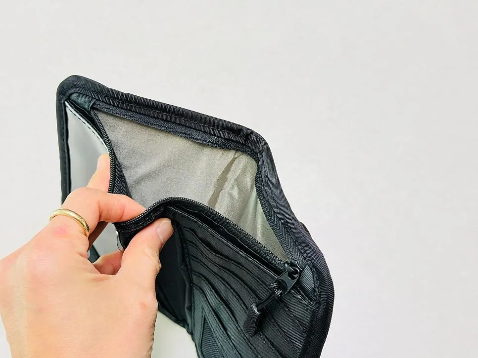 Zippered passport wallet compartment for storing cash