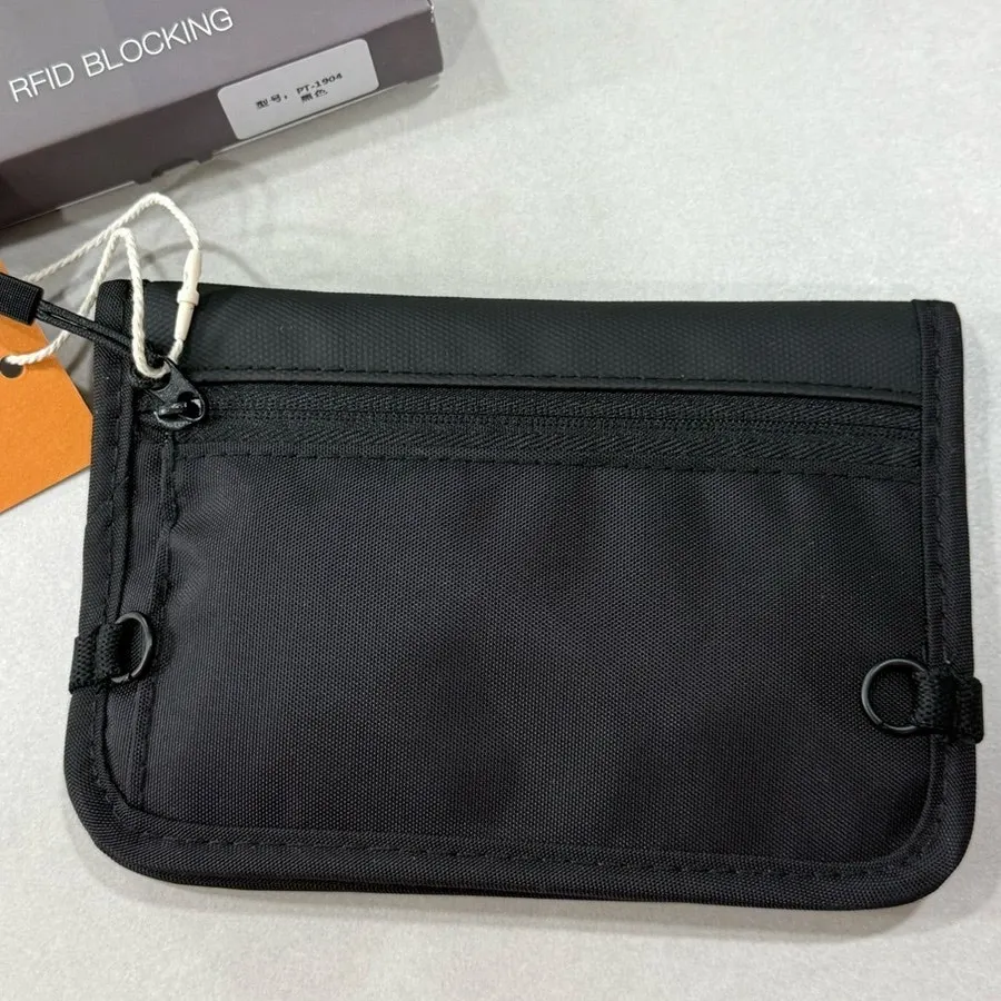 Back of the bag with a zip pocket and strap attachment ring