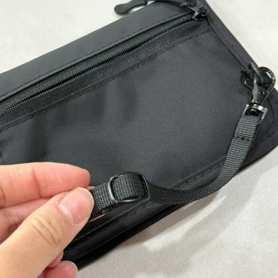 Small passport bag used with its crossbody strap