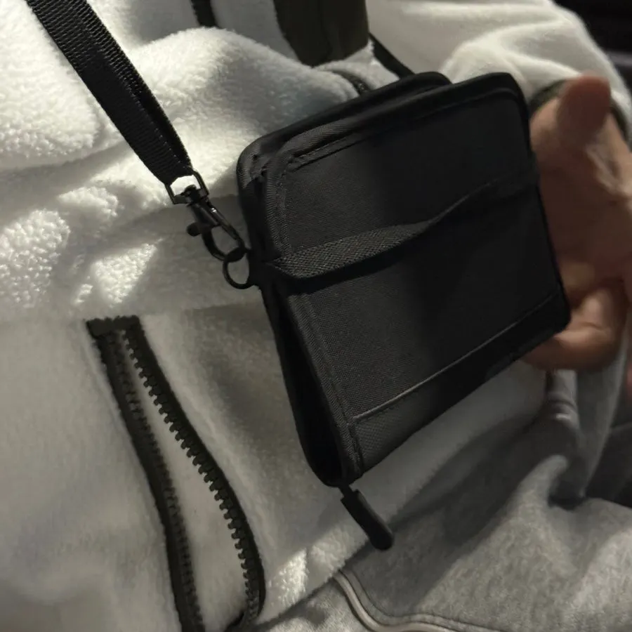 Husband wearing the slim, small Packly passport bag