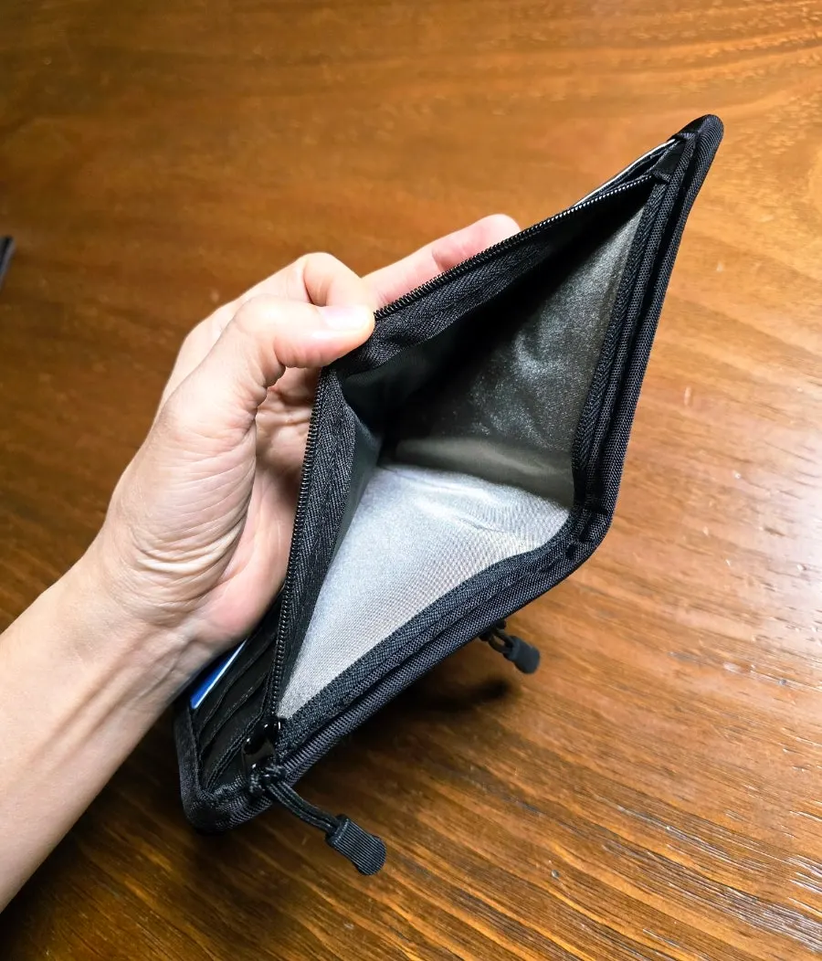 Zippered storage pocket inside the Packly passport wallet