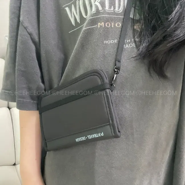 Packly passport bag worn with its adjustable strap attached