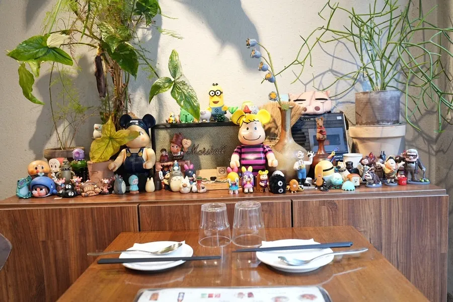 Character figure placed as if watching diners eat