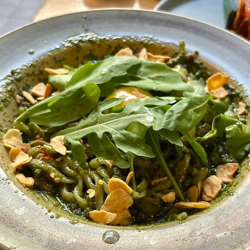 Padong's basil soba topped with egg yolk and arugula