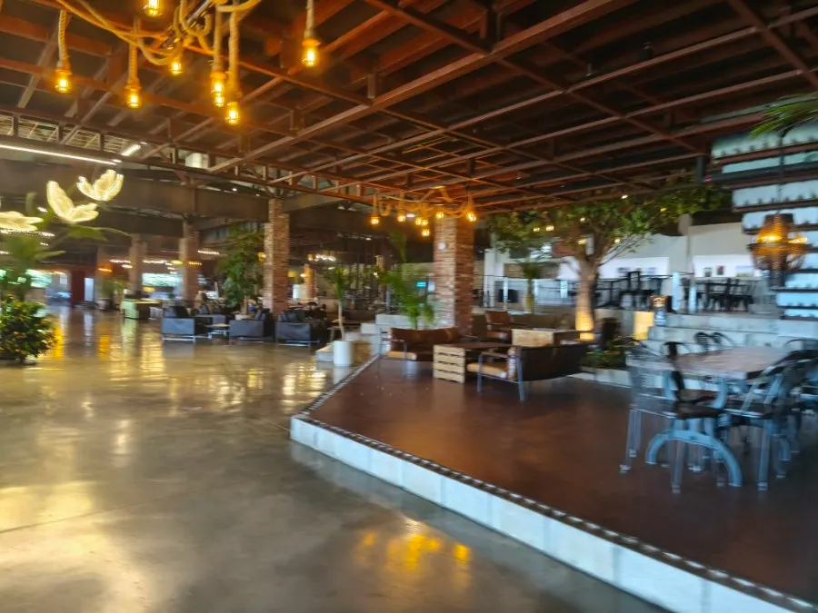 High-ceilinged 2nd-floor interior of Barirus with giant sunset media photo zone