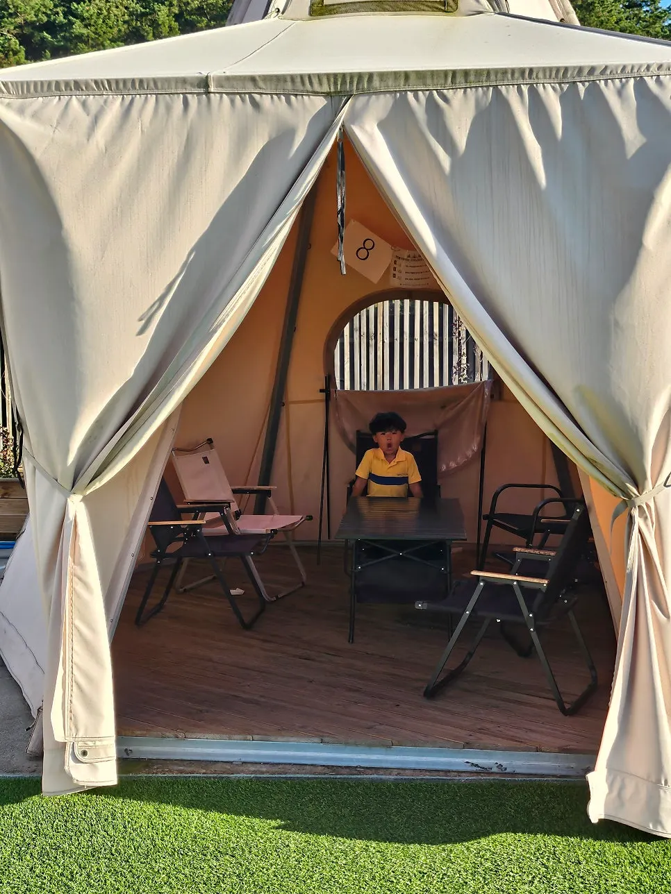 Terrace with artificial grass and tents