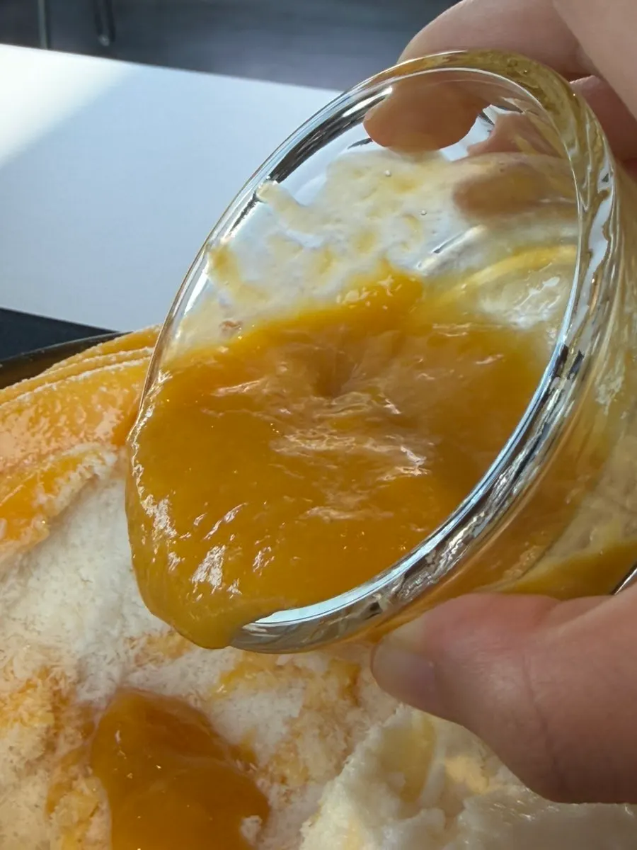 Mango snow bingsu with mango syrup poured over it