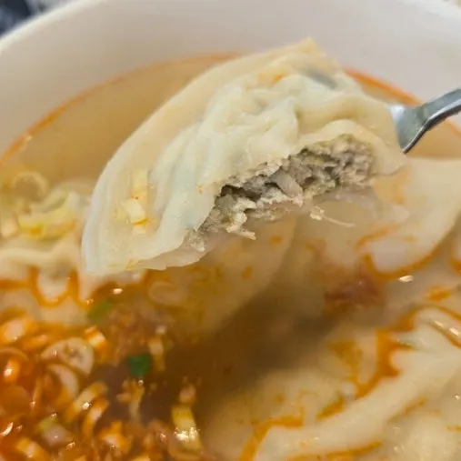 Cross-section of flat mandu in the soup