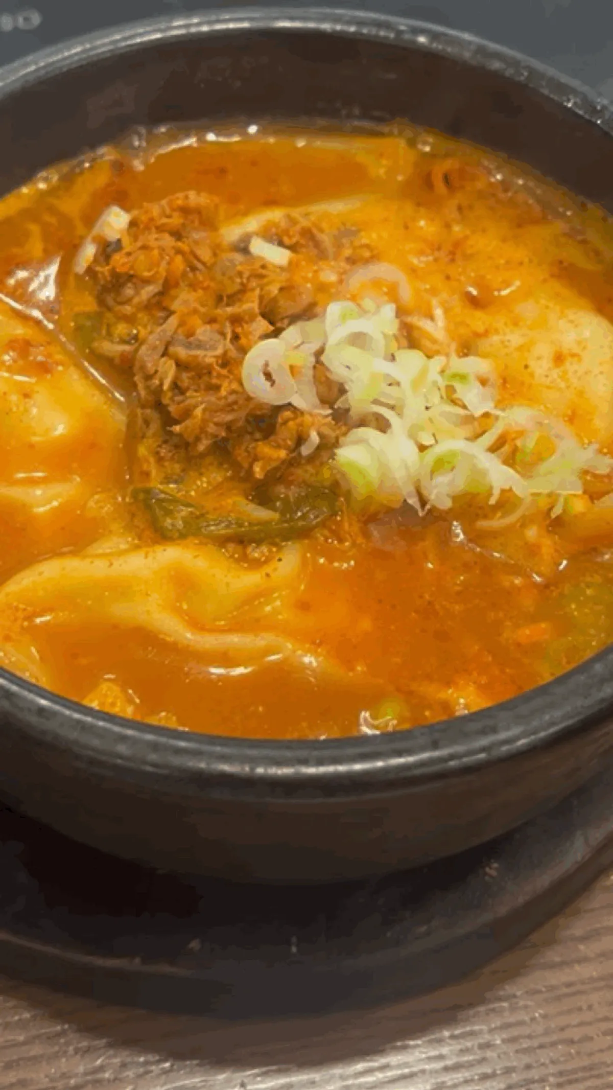 Close-up of the spicy yukgaejang-style broth in mandu jjabagi