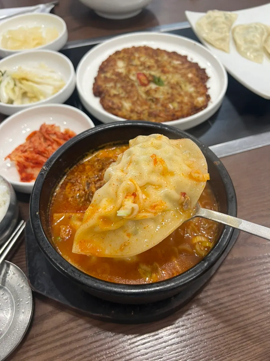 A bowl of rice served with mandu jjabagi