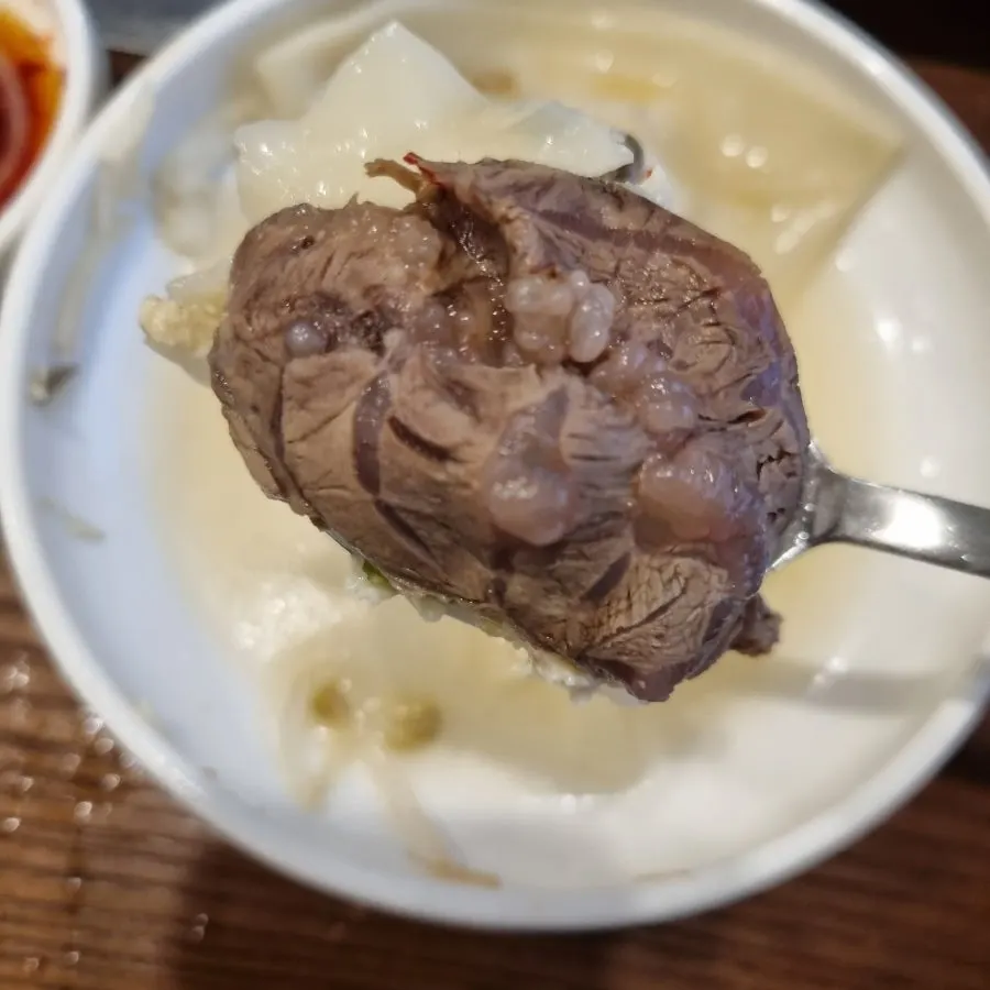 A Pyeongyang mandu split in half showing the filling