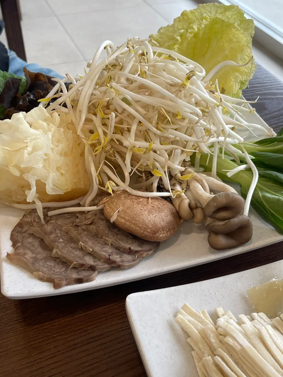 Pot of mandu hot pot filled with dumplings and vegetables