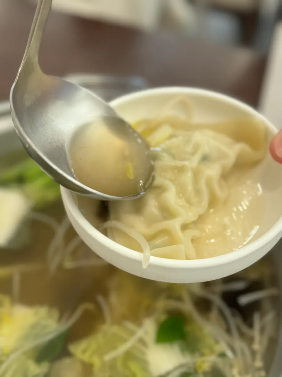 Pyeongyang dumpling cut in half showing the filling