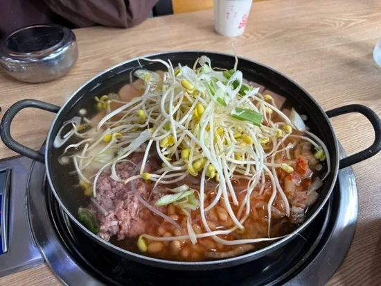 Budae jjigae table setting with included rice