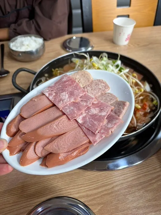 Boiling budae jjigae with bean sprouts