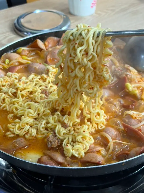 Picking out ingredients from budae jjigae