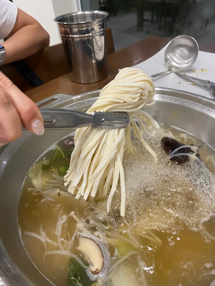 Mandu hot pot with information about the Korean beef broth