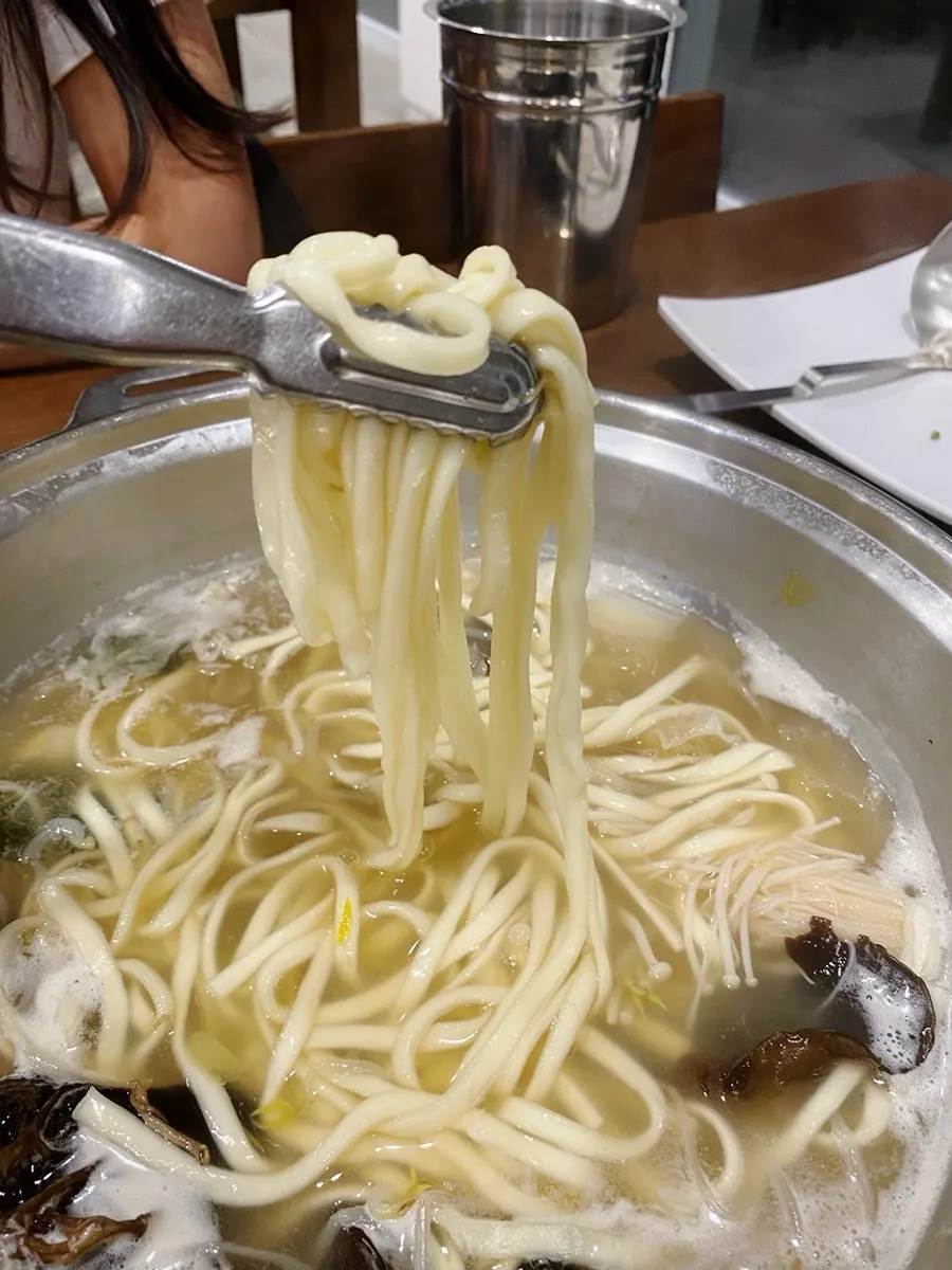 Kalguksu noodles cooking in the broth