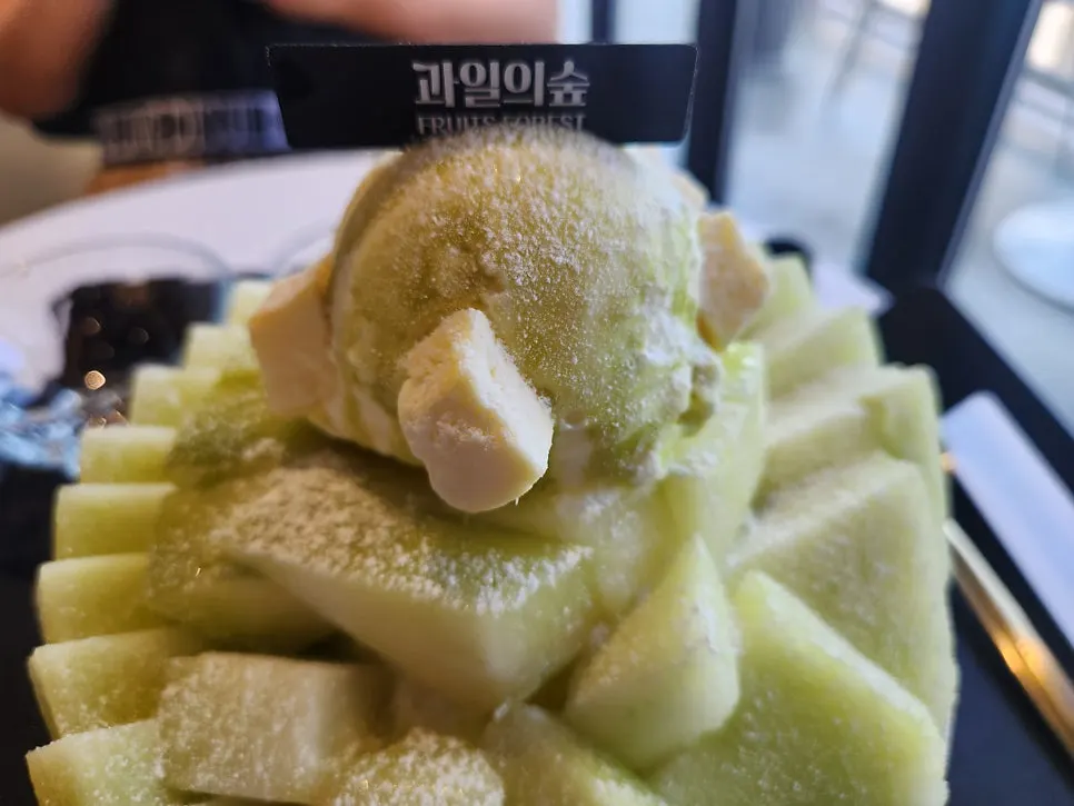 Sign reading "holy land of fresh mango bingsu"