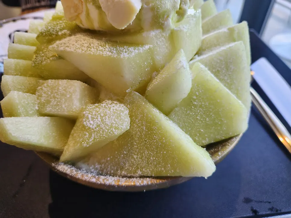 Melon snow bingsu served in a huge bowl