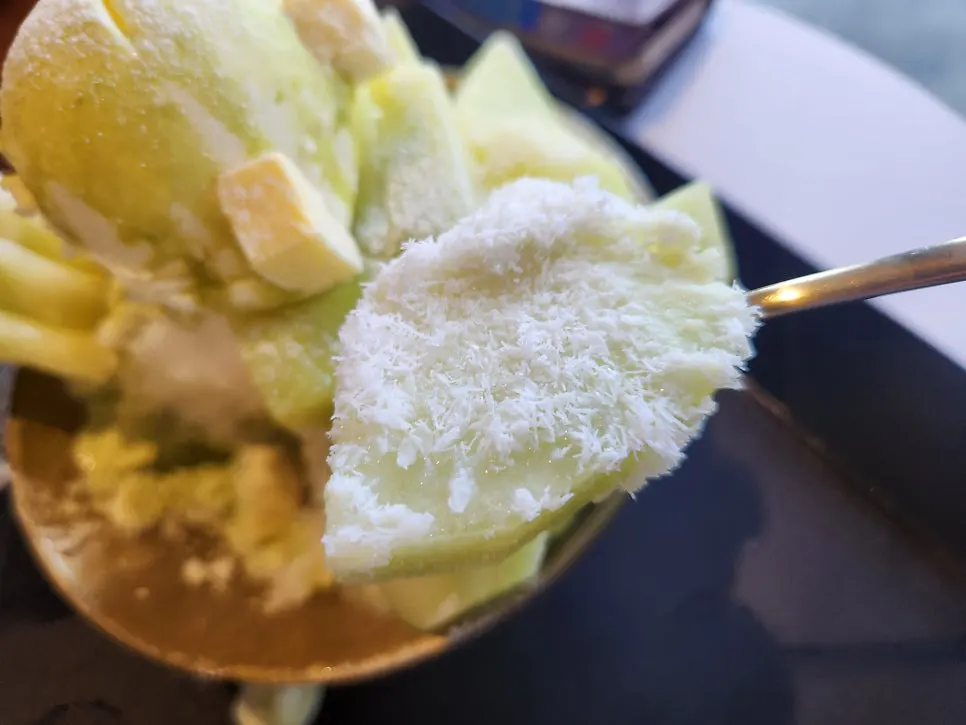 Cross-section of melon snow bingsu being scooped up