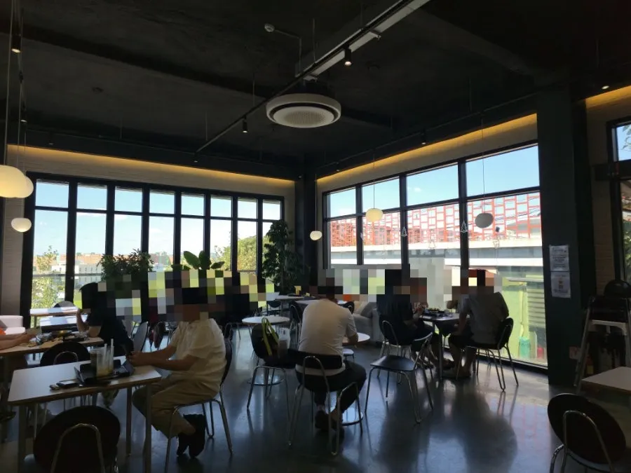 Second-floor café seating with floor-to-ceiling windows