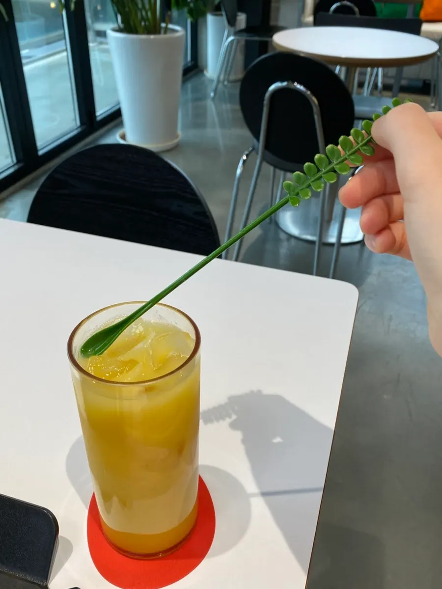 Fresh mango juice with a cute stirrer stick
