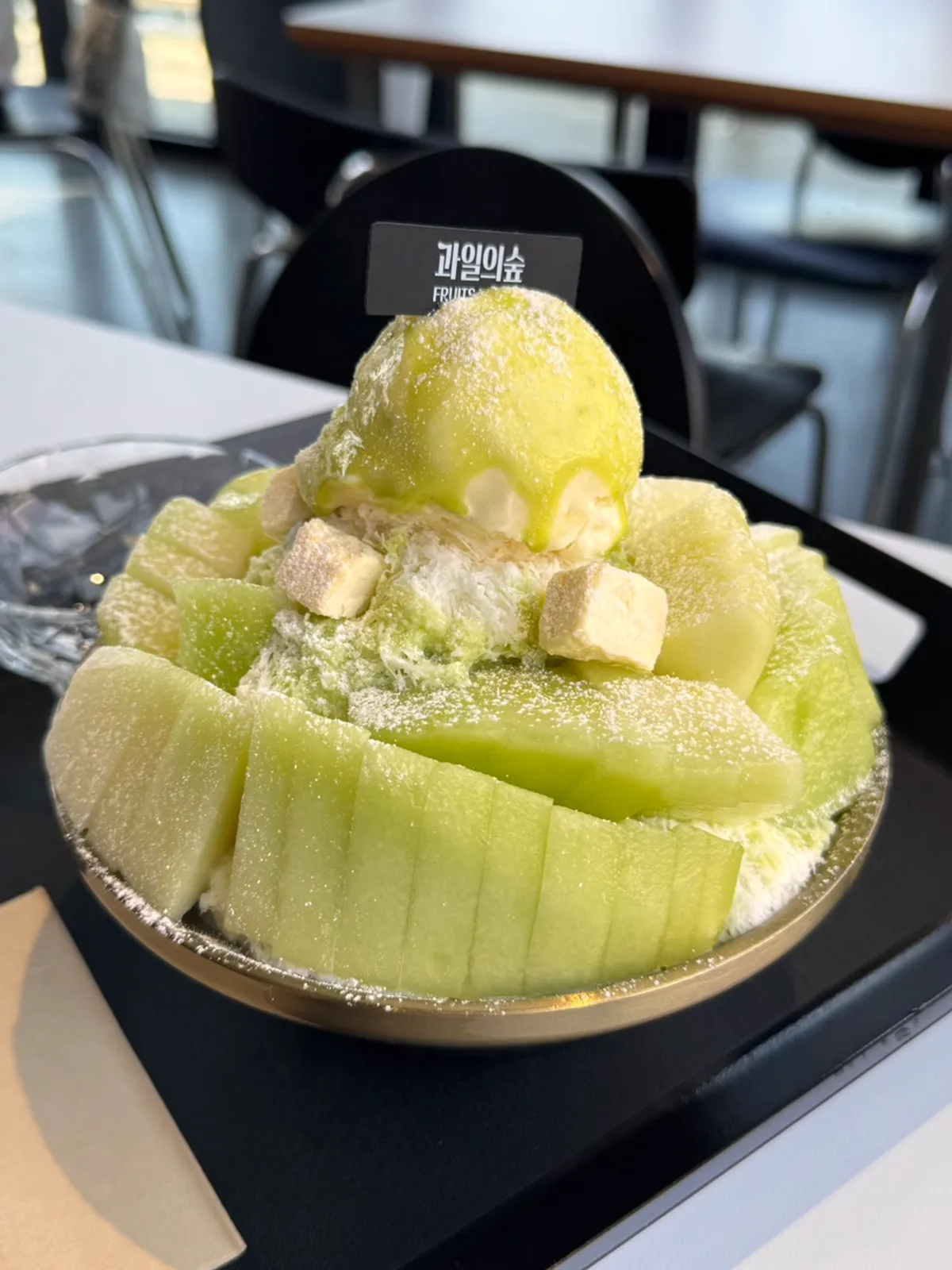 Melon snow bingsu set on a window-side table at Fruit Forest