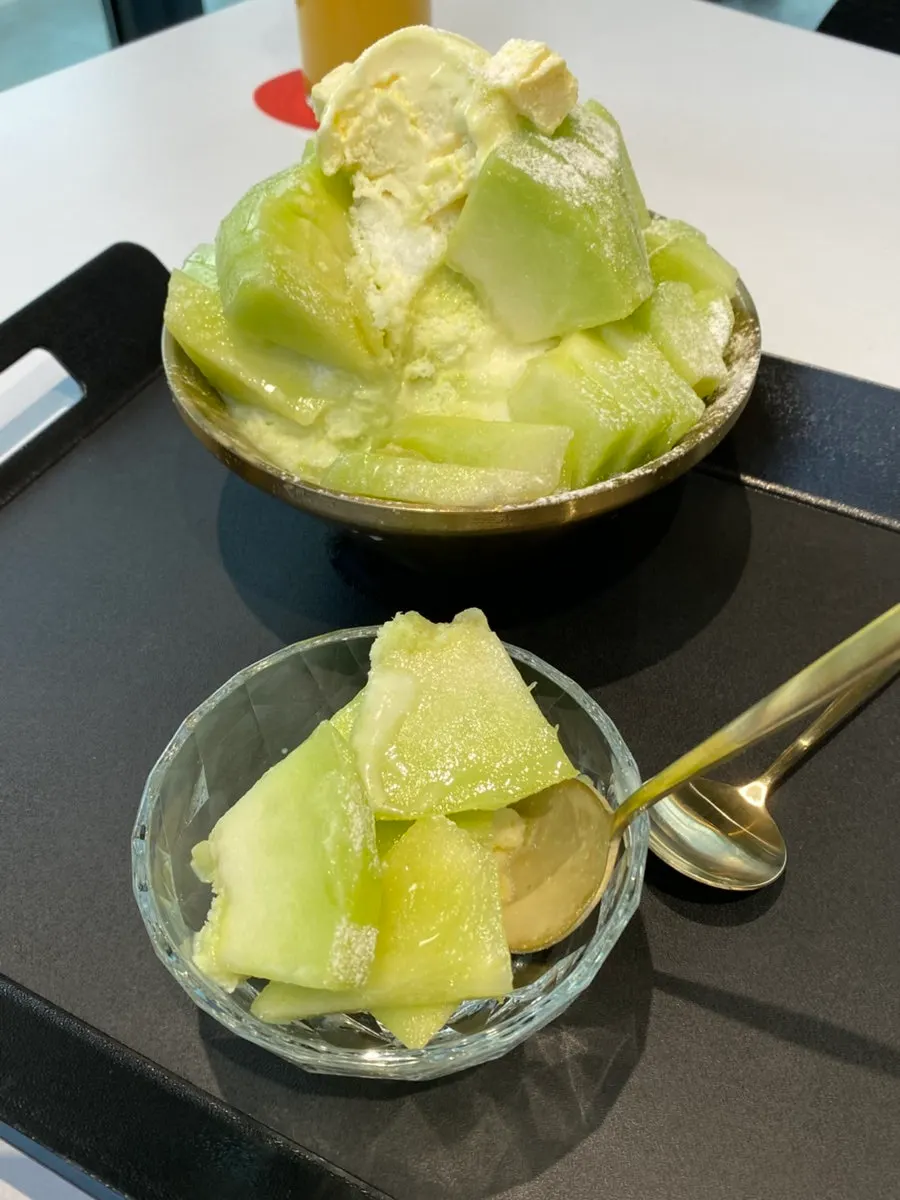 Melon snow bingsu portioned onto a small plate