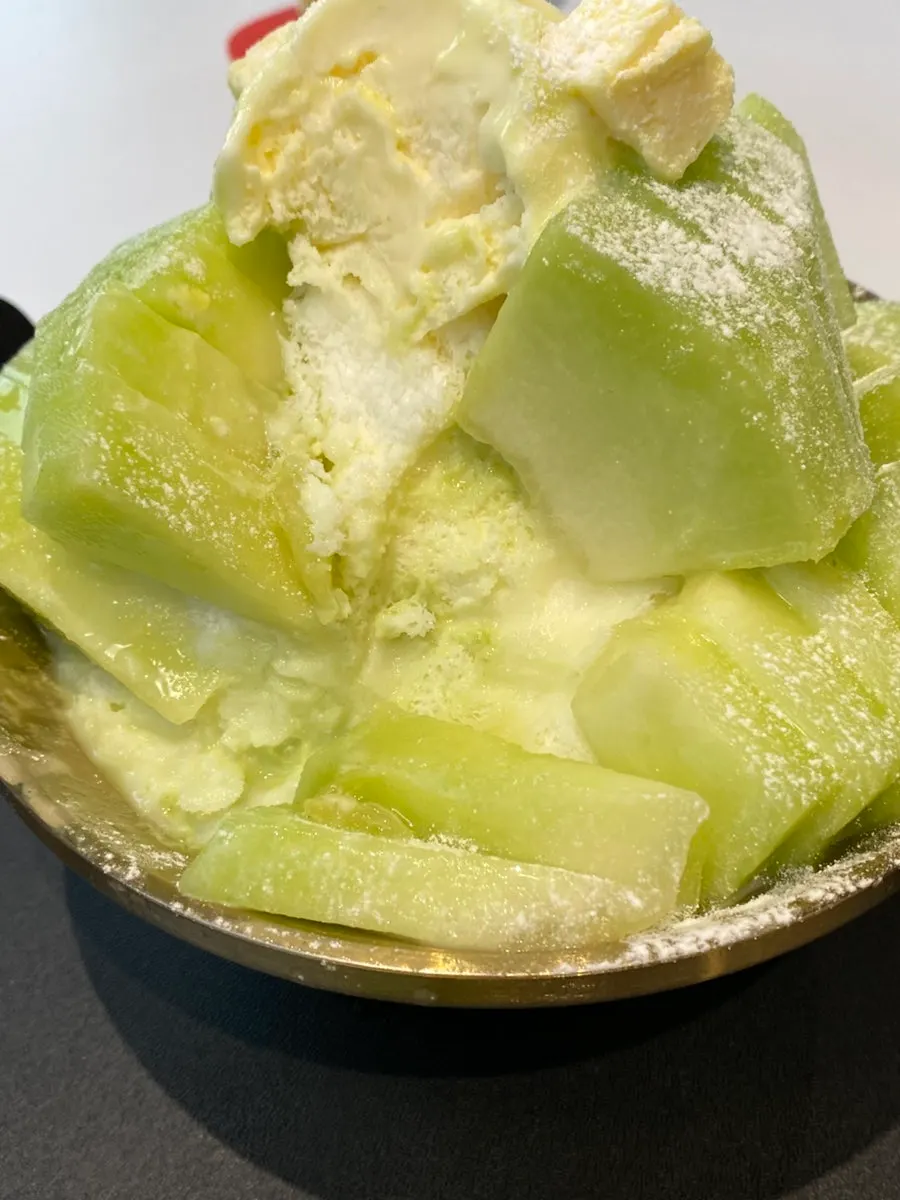 A spoonful showing the texture of the snow bingsu