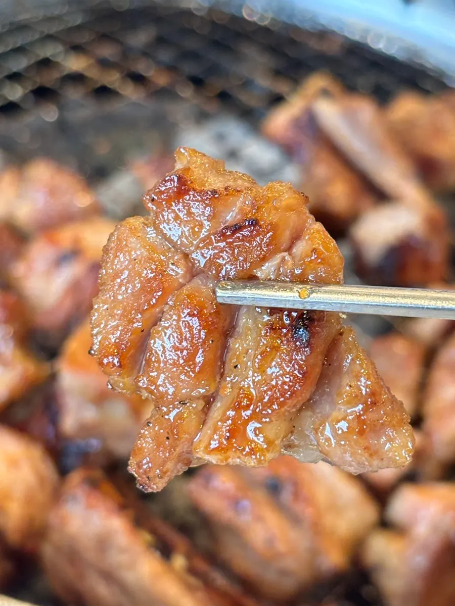 Glossy pork ribs grilled over charcoal
