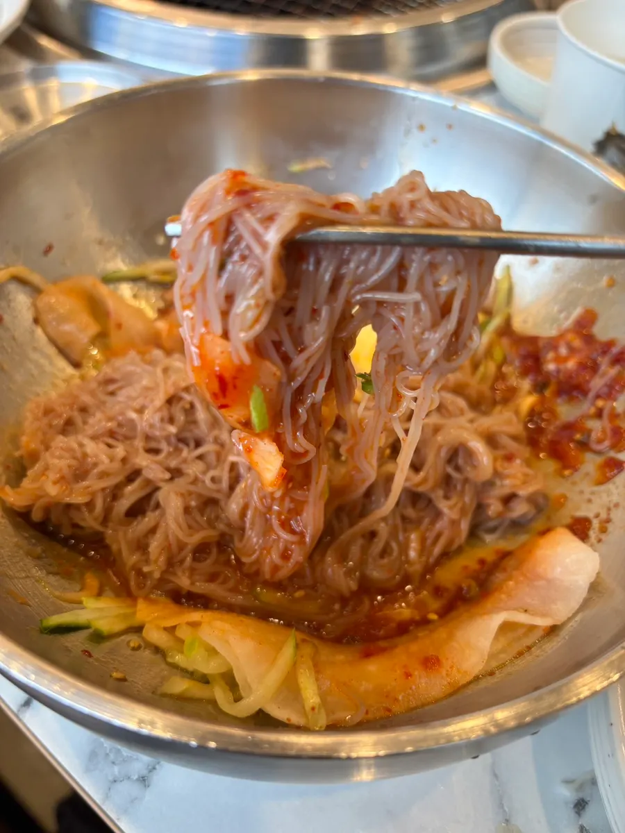Bibim naengmyeon with egg, cucumber and pickled radish wraps